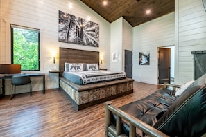 Main level has a King sized custom bark platform bed, futon leather couch and ensuite bathroom