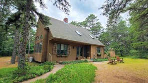 House is set on a wooded lot