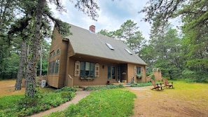 House is set on a wooded lot