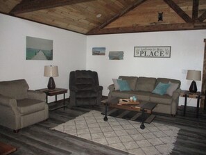 Living room has Cathedral ceilings and is open to the kitchen area