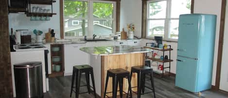 Second view of the kitchen with windows having a lake view