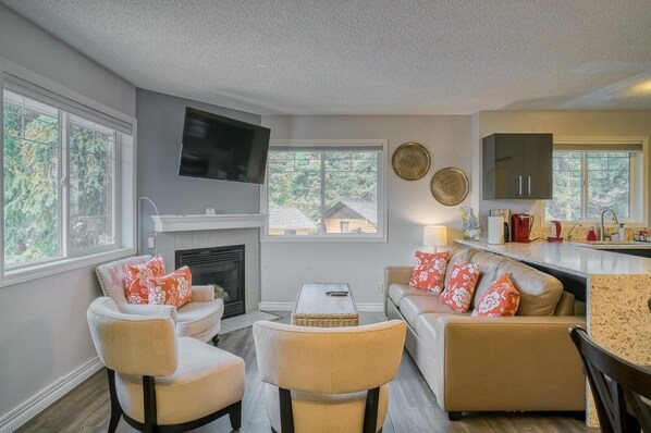 Plenty of seats by the fireplace in our cozy living room. The couch serves as a full size sofa bed, sleeps 2 more people. Extra beddings provided for the sofa bed.