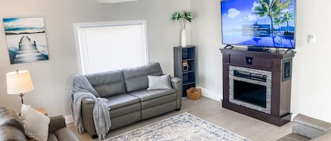 Living Room with fireplace and 65 inch TV