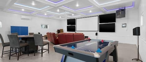 Our entertainment garage is 1,100 square feet of fun!  Custom LED ceiling, four 70-inc tv’s, 125-inc projection screen, basketball game, air hockey, table tennis, and skii ball!  Heated and cooled for use year-round.  Hulu live on all of the screens!