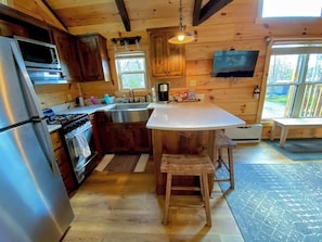 View of the kitchen and dining area. All the kitchen essentials are here to complete the dining experience. Microwave, oven, dishwasher, toaster, and drip-style coffee for coffee enthusiasts.