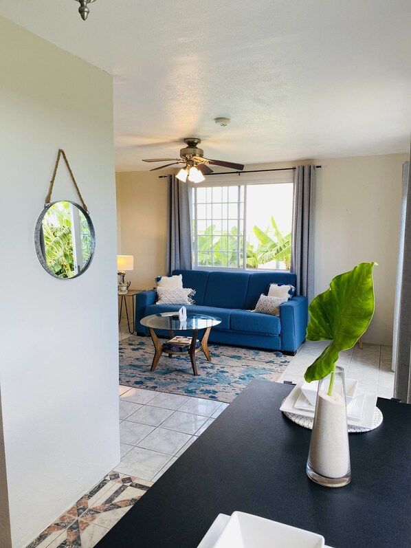 Spacious living area with open dining area and ocean views 