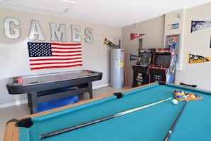 Fun games room with pool table, air hockey, foosball, two arcade machines