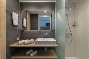 Get ready for your day in the bright bathroom.