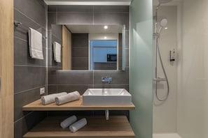 Get ready for your day in the bright bathroom.