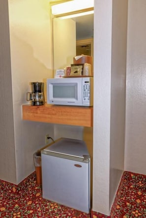 No kitchen, but don’t worry, there’s a mini fridge + microwave in each unit!