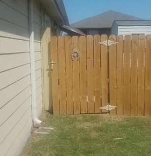 Entrance to the apartment is around the right side of the house and through gate