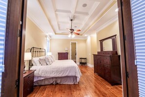 Master bedroom with double doors opening to porch overlooking the lake. 