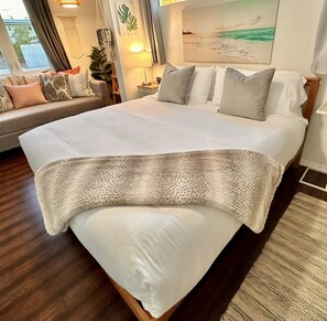 Ultra plush king size bed in a roomy bedroom with a coastal boho daybed 