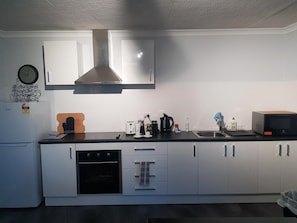 Fully fitted out kitchen, electric oven and hob. Nespresso Machine, and utensils