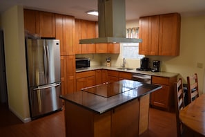 Enjoy cooking in the custom kitchen, supplied with cookware, dishes, & utensils