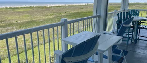 Patio has 2 rocking chairs w/ a table, dining table wi/ 4 chairs, and 2 loungers