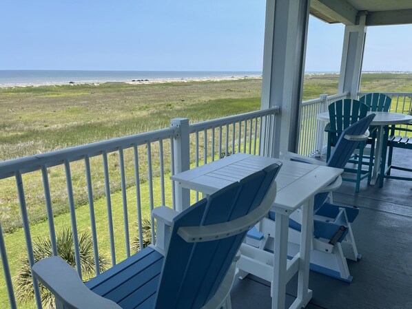 Patio has 2 rocking chairs w/ a table, dining table wi/ 4 chairs, and 2 loungers