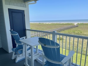 The balcony is large with room to have coffee in the rocking chairs.