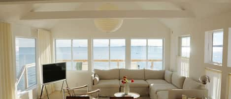 Living room with unobstructed water views on three sides 