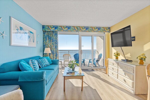 Relax in the comfort of a large well-appointed living room with an ocean view.