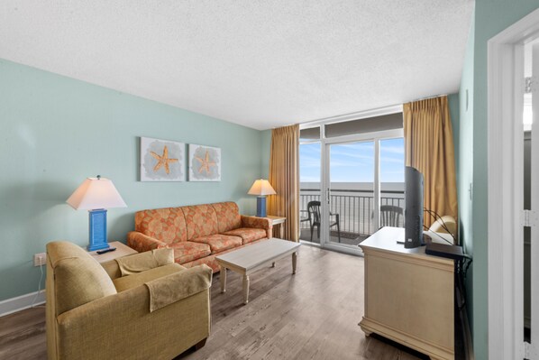 The ocean front living room is well-appointed with comfortable furnishings.