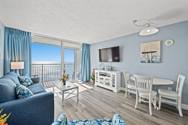 The ocean front living room is well-appointed with comfortable furnishings.