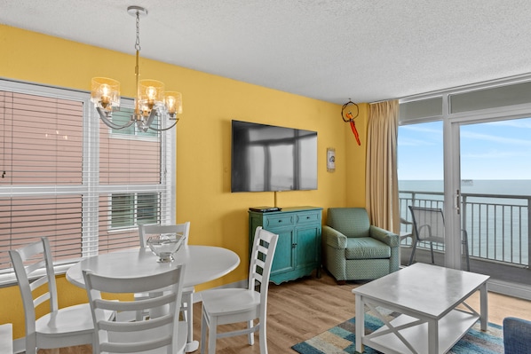 Relax in the comfort of a large well-appointed living room with an ocean view.