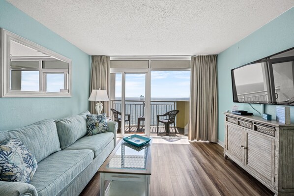 Relax in the comfort of a well-appointed living room with an oceanfront view.