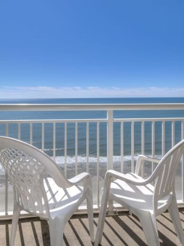 Sit outside and relax on this ocean view balcony and listen to the waves.