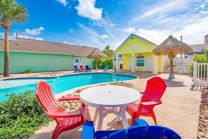 Resort style pool with chairs & loungers. 