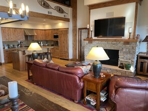 Living room with fireplace and a well-appointed kitchen.