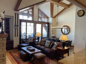 The living room has high ceilings and magnificent wood beams.