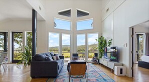 Living room with gorgeous windows, smart tv, and sleeper sofa