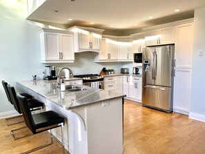 Open concept kitchen with stainless steel appliances