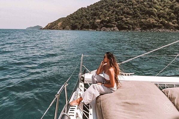 Charter a luxury yacht for a day cruise on the Andaman Sea, etc. with lush views