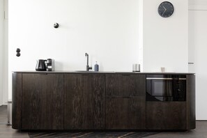 The sleek design of the kitchenette blending seamlessly with the living area.