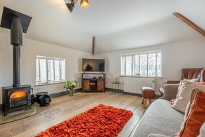 The Hideaway, Great Massingham: Sitting area with a wood burning stove