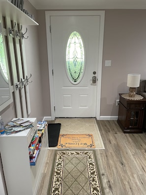 Entryway with storage, umbrellas, brochures and family games! 
