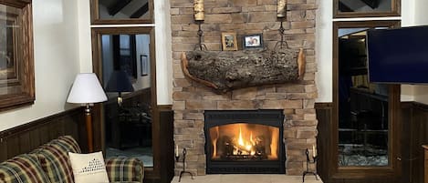 Living room at night with gas fireplace.