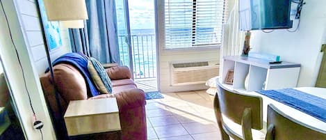 Living room with a balcony and Beachfront View.