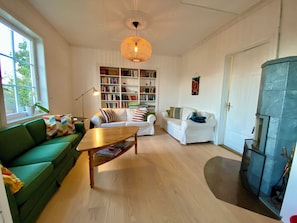 Living room with wood burning oven and TV