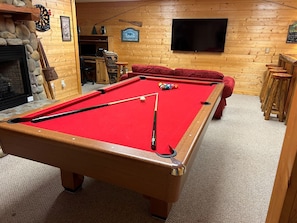 Unwind with a game of pool, in front of the 65" TV, or with a drink at the unique, live-edge bar!