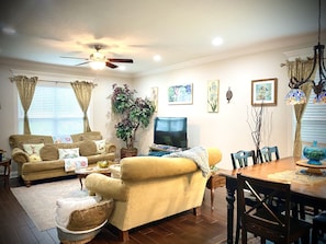 The vibrant and spacious living room allows an abundance of natural lighting.