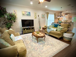 The vibrant and spacious living room allows an abundance of natural lighting.