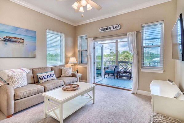 Living room opens to a private balcony