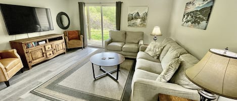 Family room with sleeper sofa and 55" smart TV