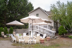 Firepit seating next to deck and grill.