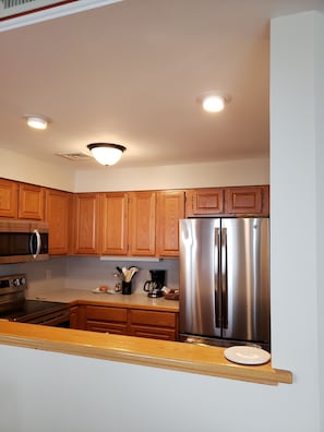 Up-to-date kitchen appliances. View from the dining room.