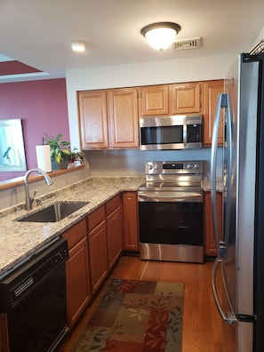 Kitchen has: cookware, utensils, dish towel, mixer, drip coffee, French press...
