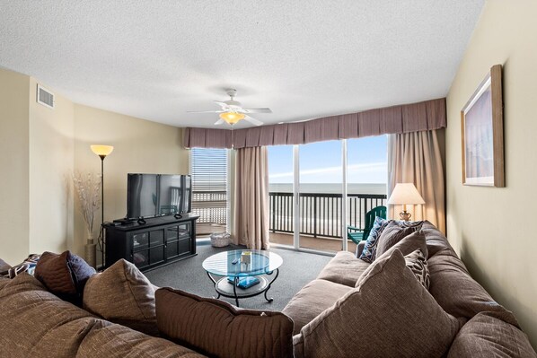 Relax in the comfort of a large well-appointed living room with an ocean view.